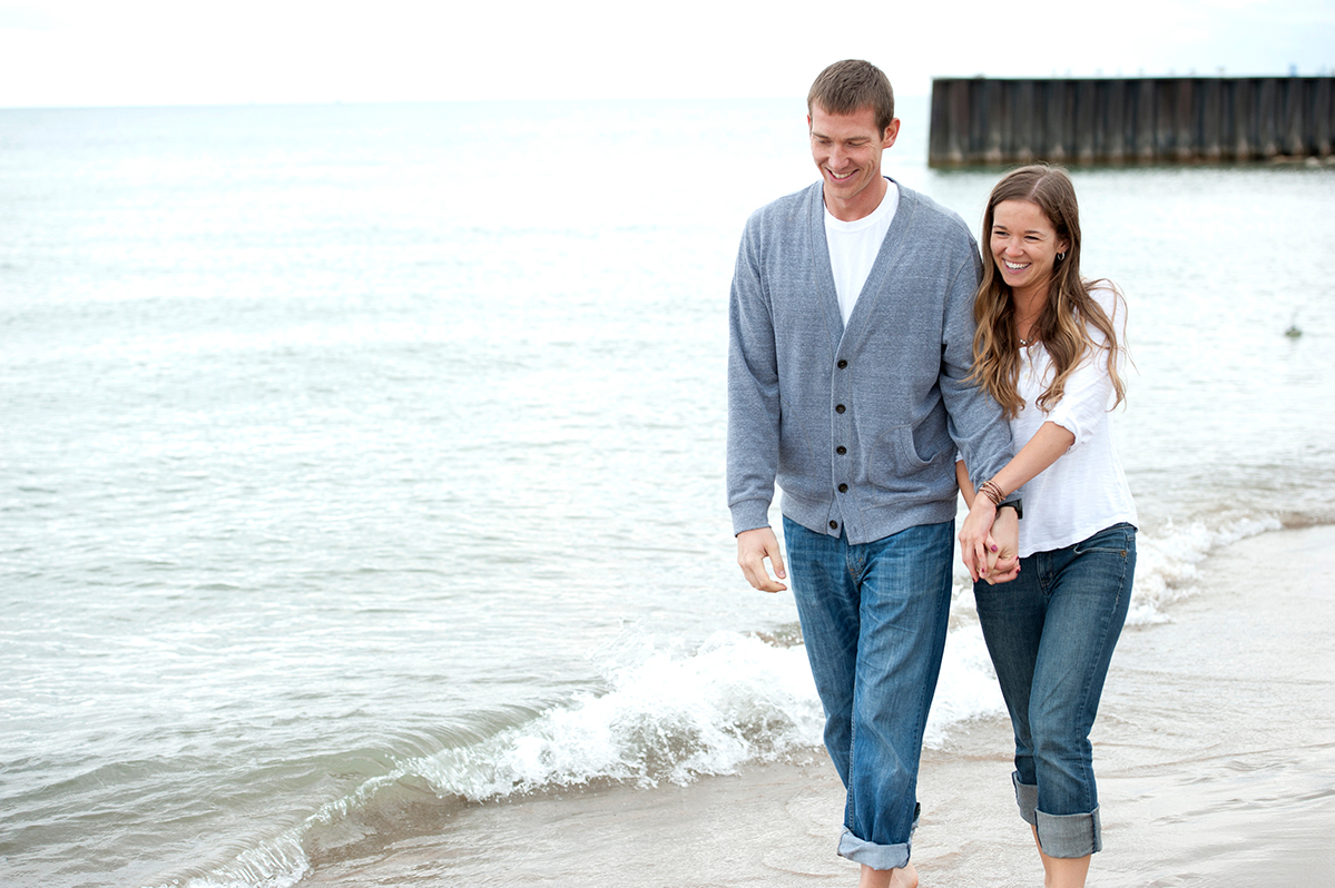 A couple walking on the beach, reflecting the security of sound investments.
