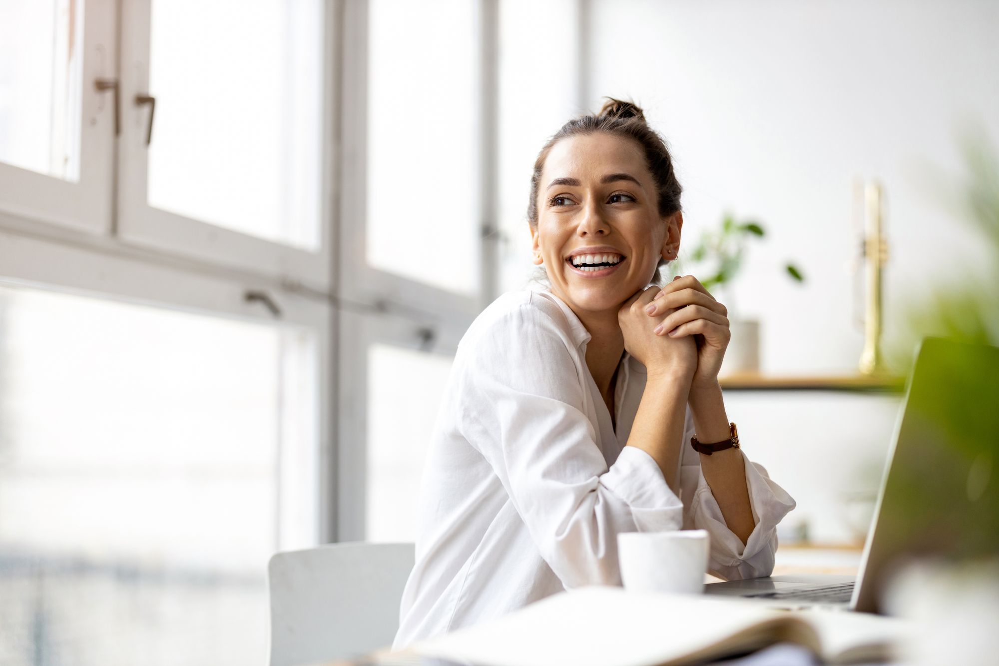Happy woman banking online with Northern Birch Credit Union