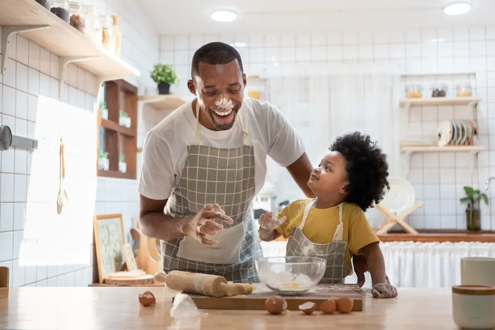 A father and son having fun in the kitchen together. A flex mortgage for all life stages.