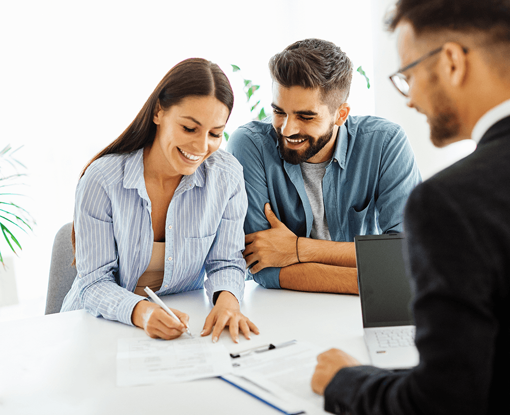 A couple signing a mortgage agreement.