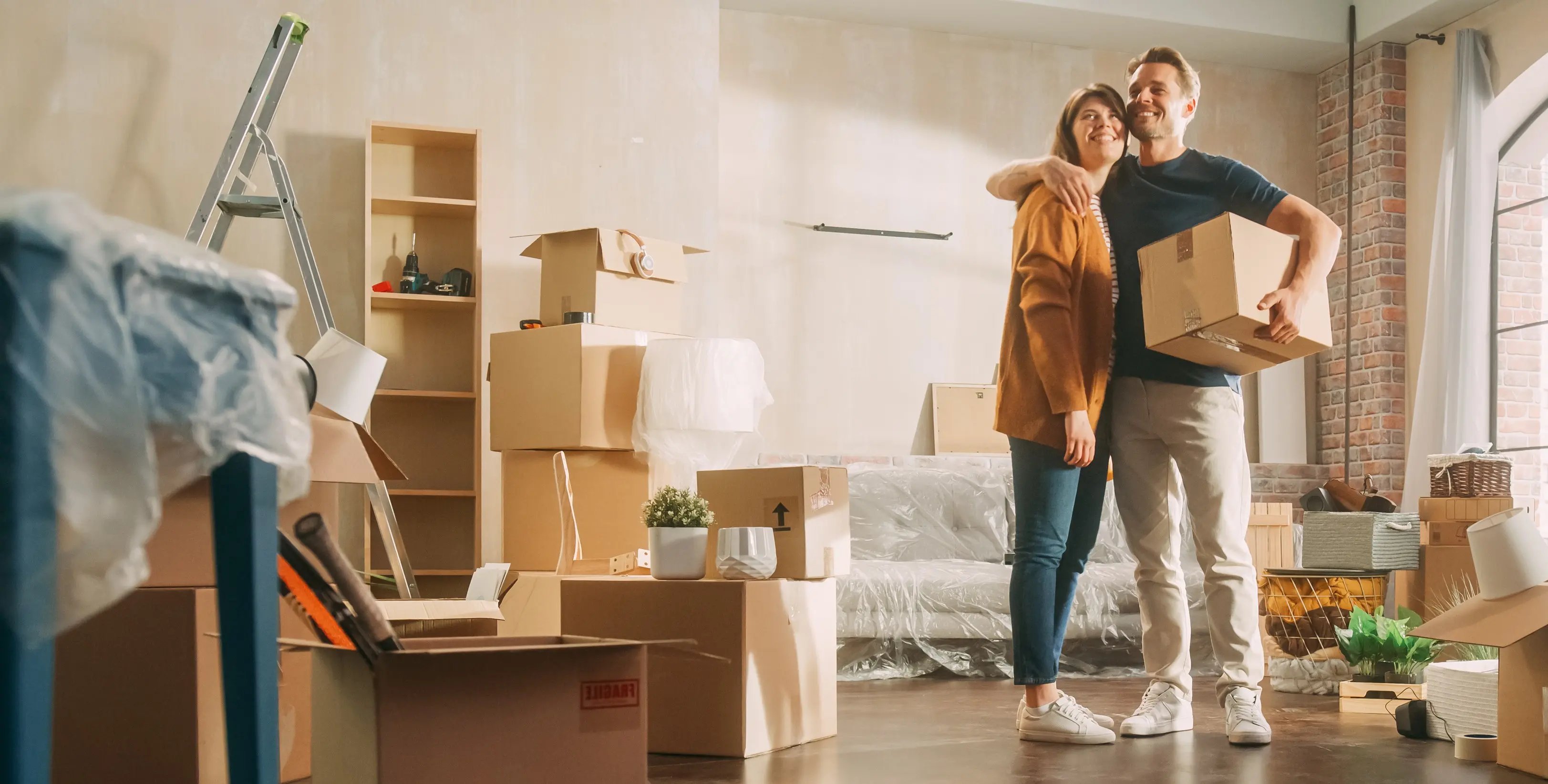 A couple standing happy together in their new condo