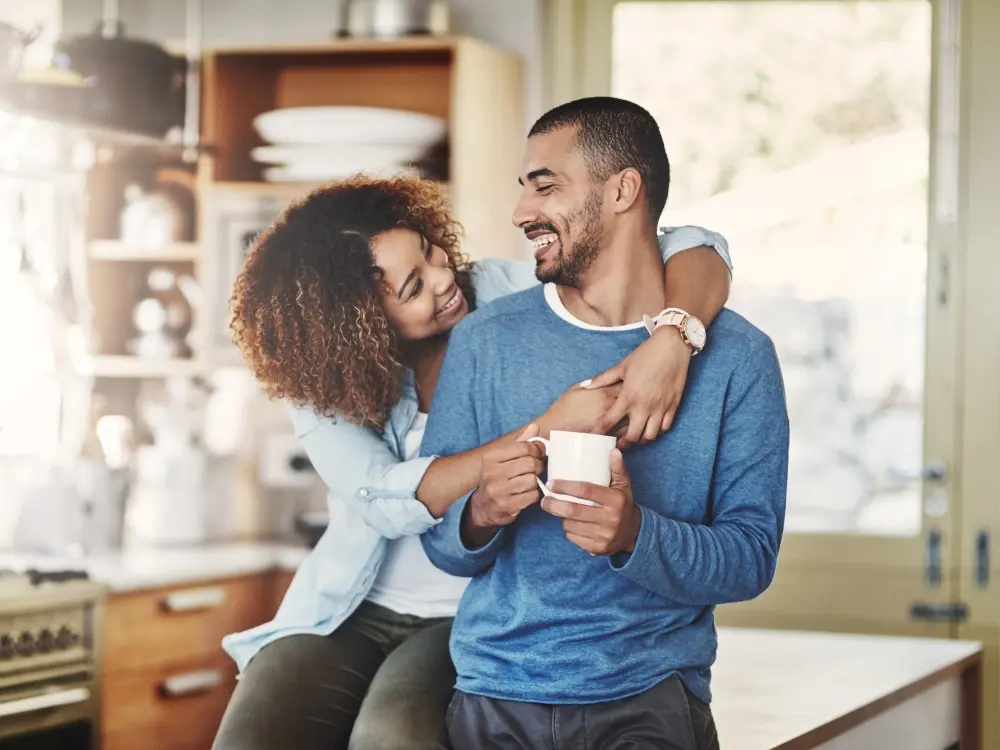 A couple smiling in their new home