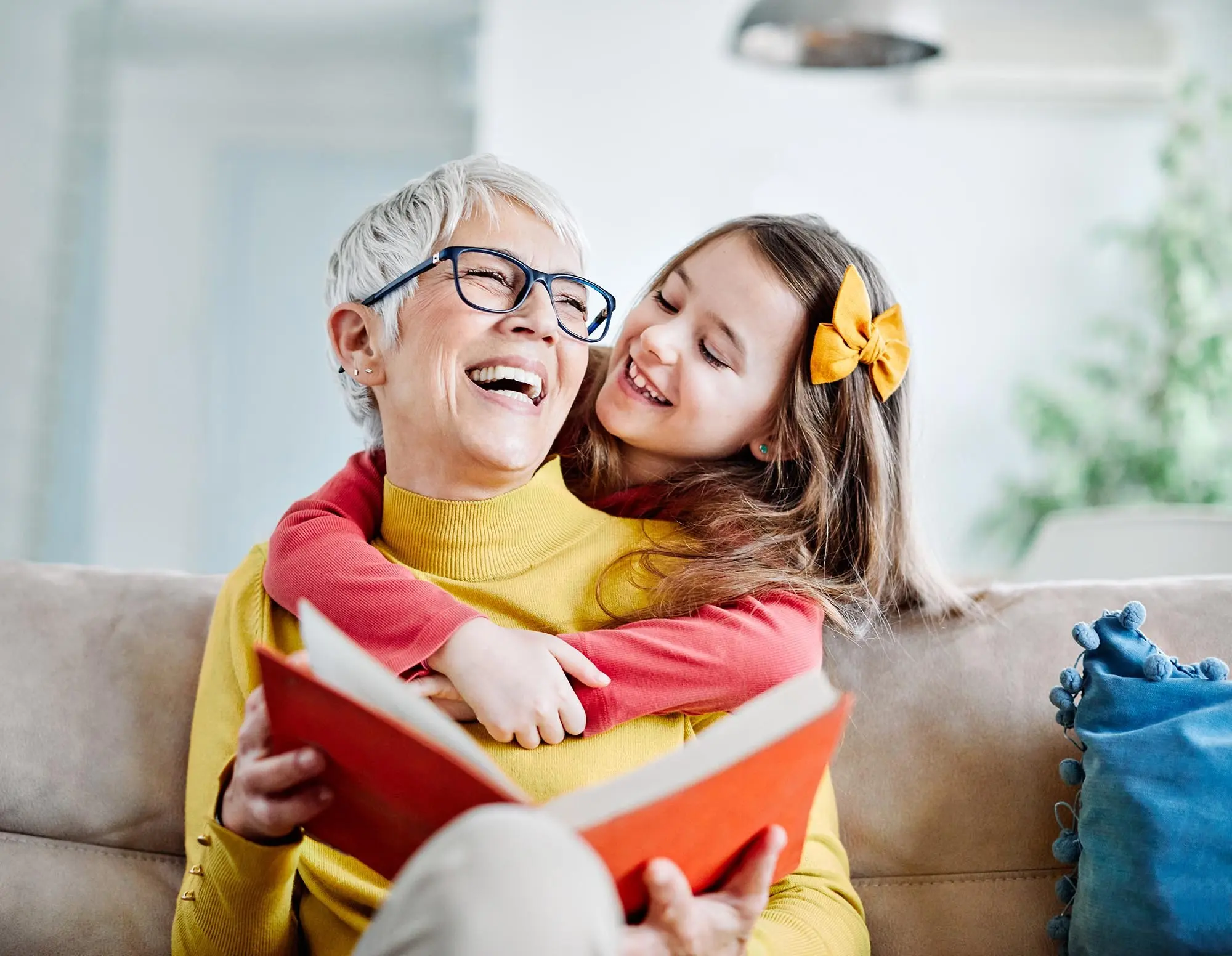 A grandmother and granddaughter reading a book, reflecting secure retirement with an RRSP