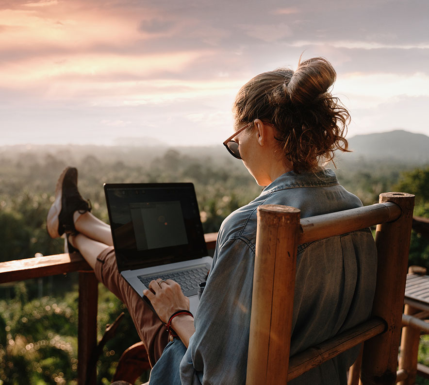 Young woman on a laptop considering a Premium Savings Account